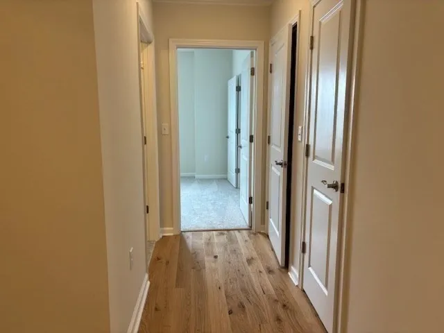 a view of a hallway with wooden floor
