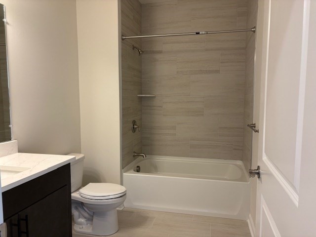 4 Stratton Drive, Unit 301 Woburn, MA 01801 - Photo 19 of 24 a bathroom with a bathtub shower sink vanity and toilet