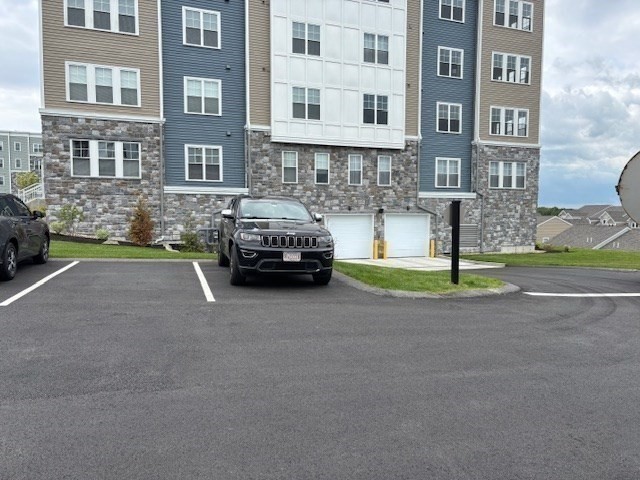 4 Stratton Drive, Unit 301 Woburn, MA 01801 - Photo 3 of 24 a car parked in front of a brick building