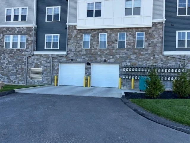 a front view of a house with a yard and a garage