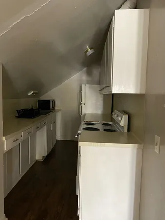 a kitchen with a stove and a refrigerator