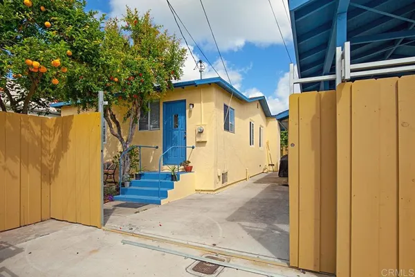 a view of a house with a wooden fence