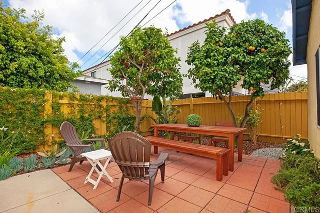 a patio with garden area and outdoor seating