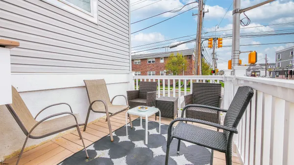 a view of a chairs and table in the balcony
