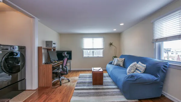a living room with furniture a flat screen tv and a fireplace