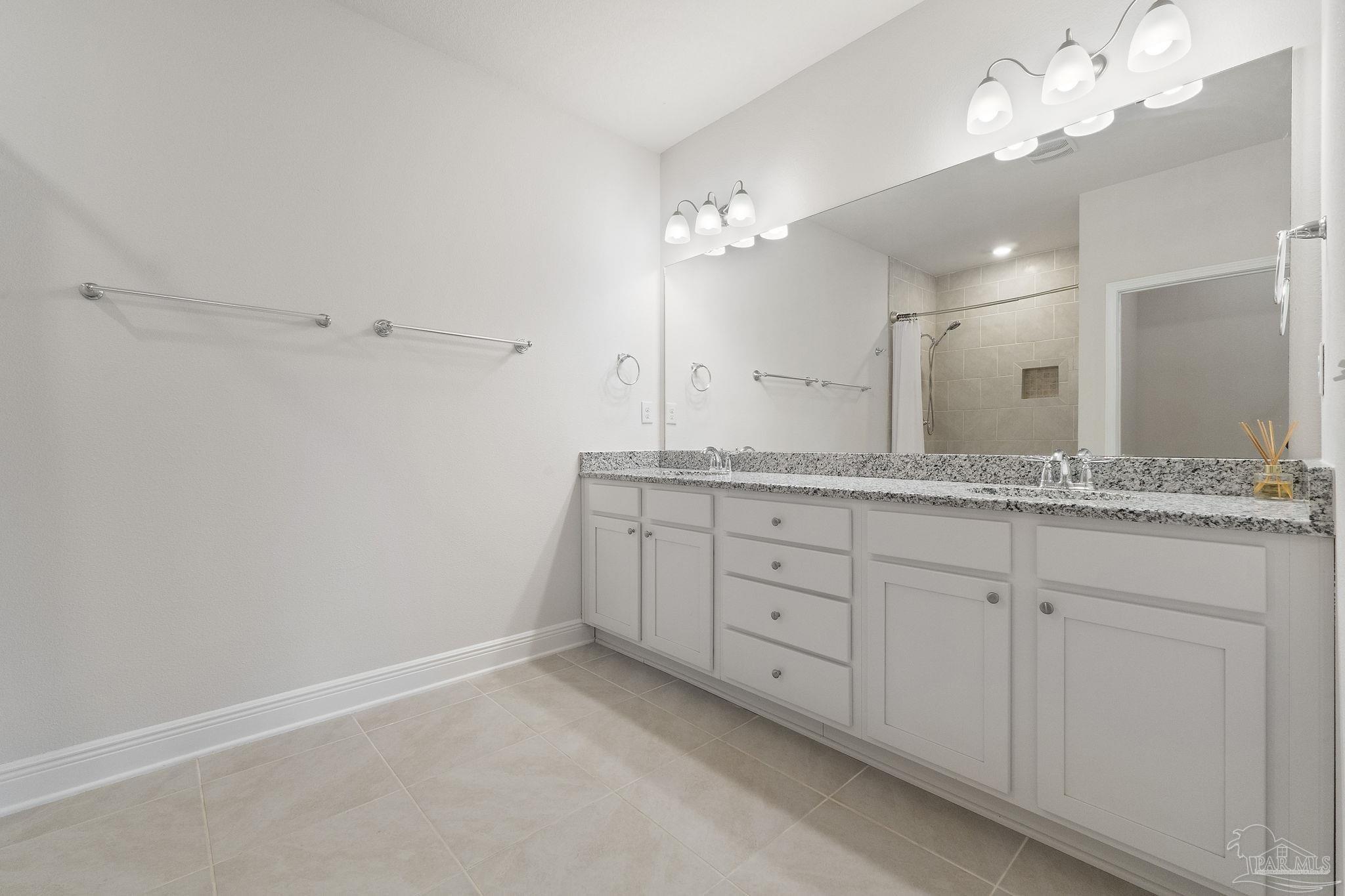 7737 Burnside Loop Pensacola, FL 32526 - Photo 15 of 33 a bathroom with a granite countertop double vanity sink and mirror