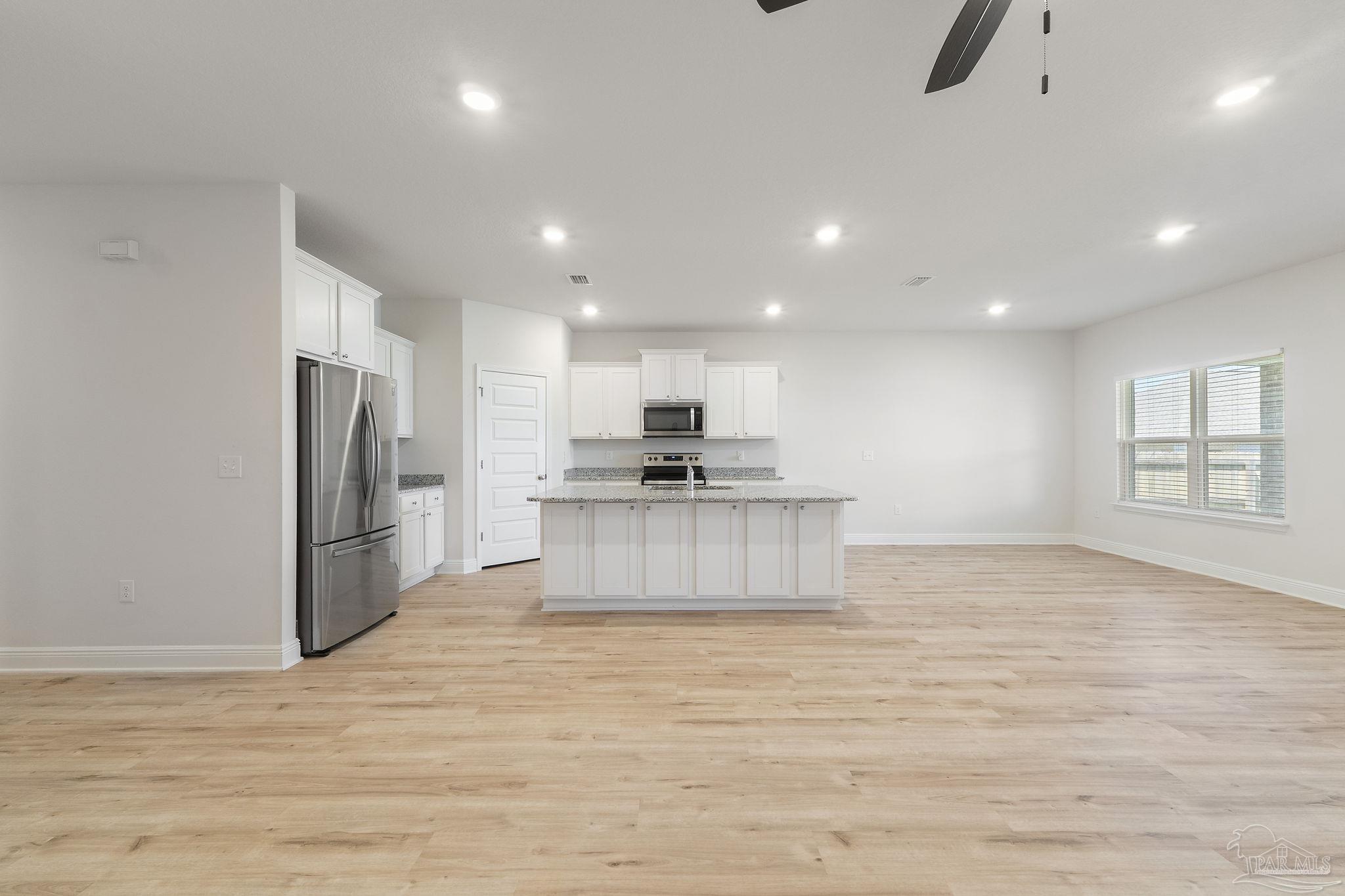 7737 Burnside Loop Pensacola, FL 32526 - Photo 8 of 33 a view of kitchen with stainless steel appliances granite countertop a stove a refrigerator a sink and a microwave