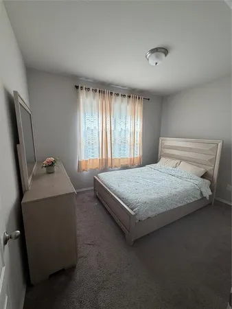 a bedroom with bed and window