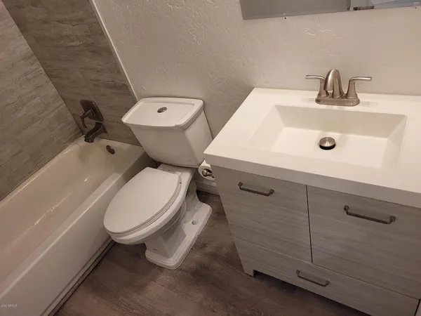 a white toilet sitting next to a bathroom sink
