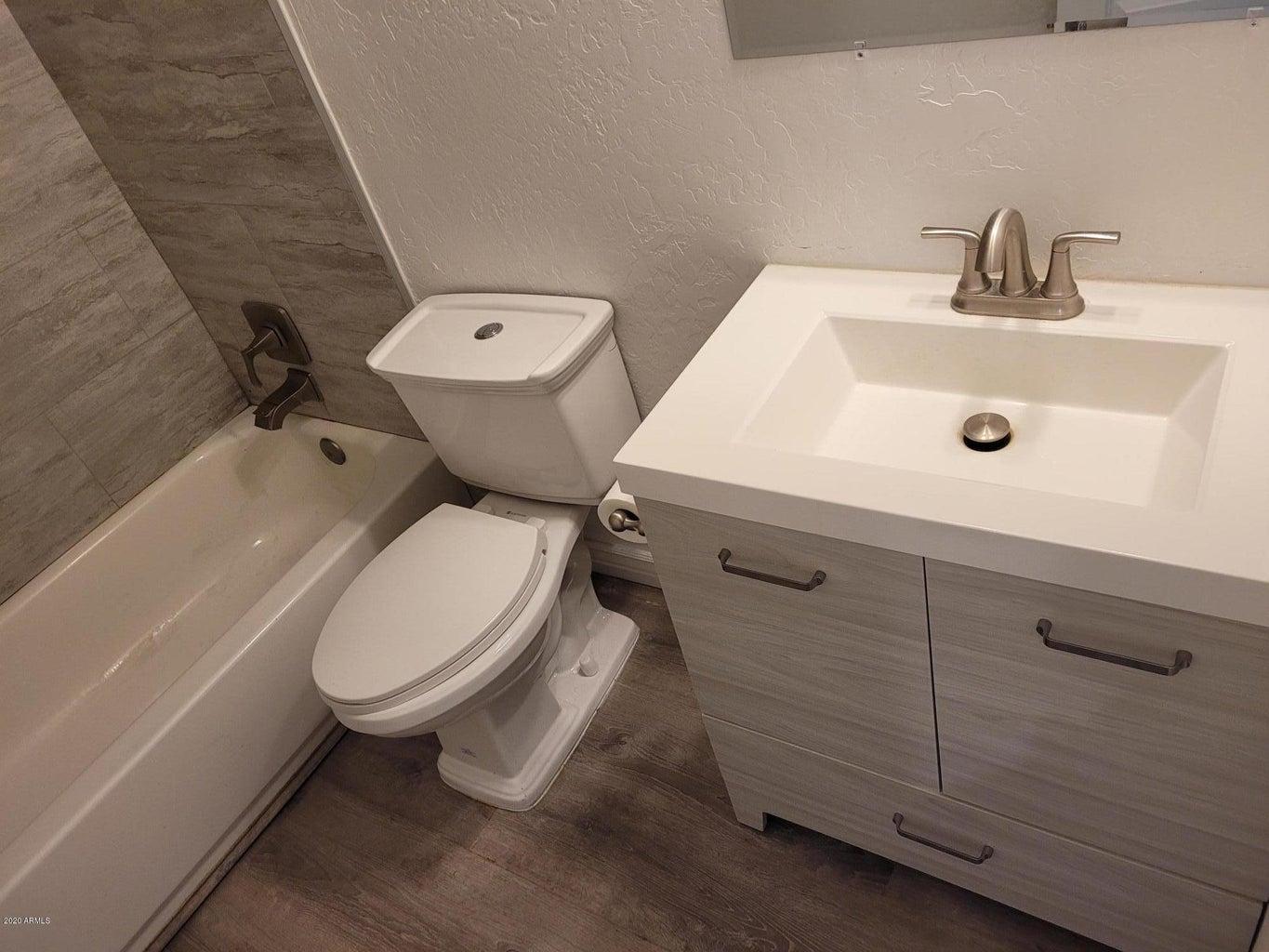 6713 East Cheery Lynn Road, Unit 2 Scottsdale, AZ 85251 - Photo 8 of 8 a white toilet sitting next to a bathroom sink