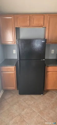 a kitchen with granite countertop a sink and cabinets