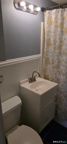 a bathroom with a toilet and a shower
