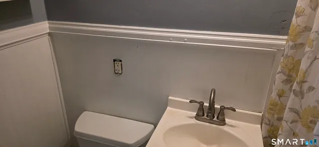 a bathroom with a shower curtain and a sink