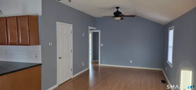 wooden floor in an empty room with a window