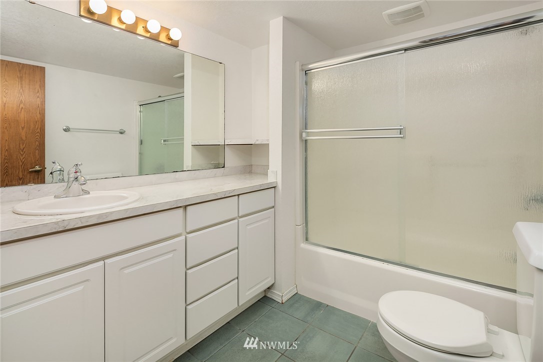 521 South 28th Place Renton, WA 98055 - Photo 16 of 20 a bathroom with a granite countertop sink toilet and shower