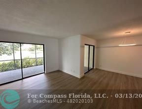 Undisclosed Address Fort Lauderdale, FL 33319 - Photo 7 of 19 an empty room with wooden floor and windows