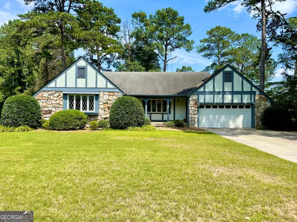 a front view of a house with a garden