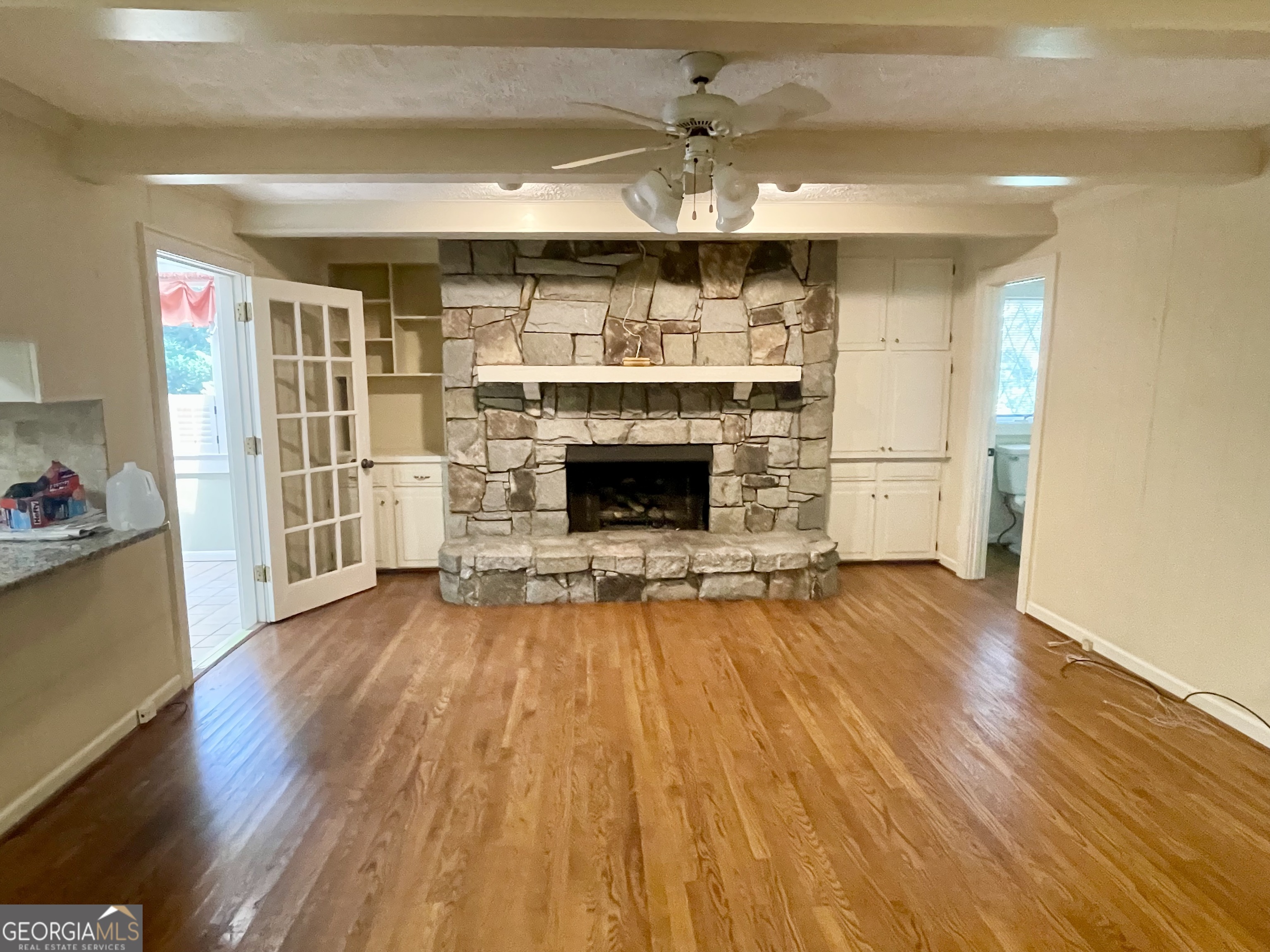 11 Cumberland Drive Southeast Rome, GA 30161 - Photo 12 of 29 an empty room with wooden floor fireplace and chandelier