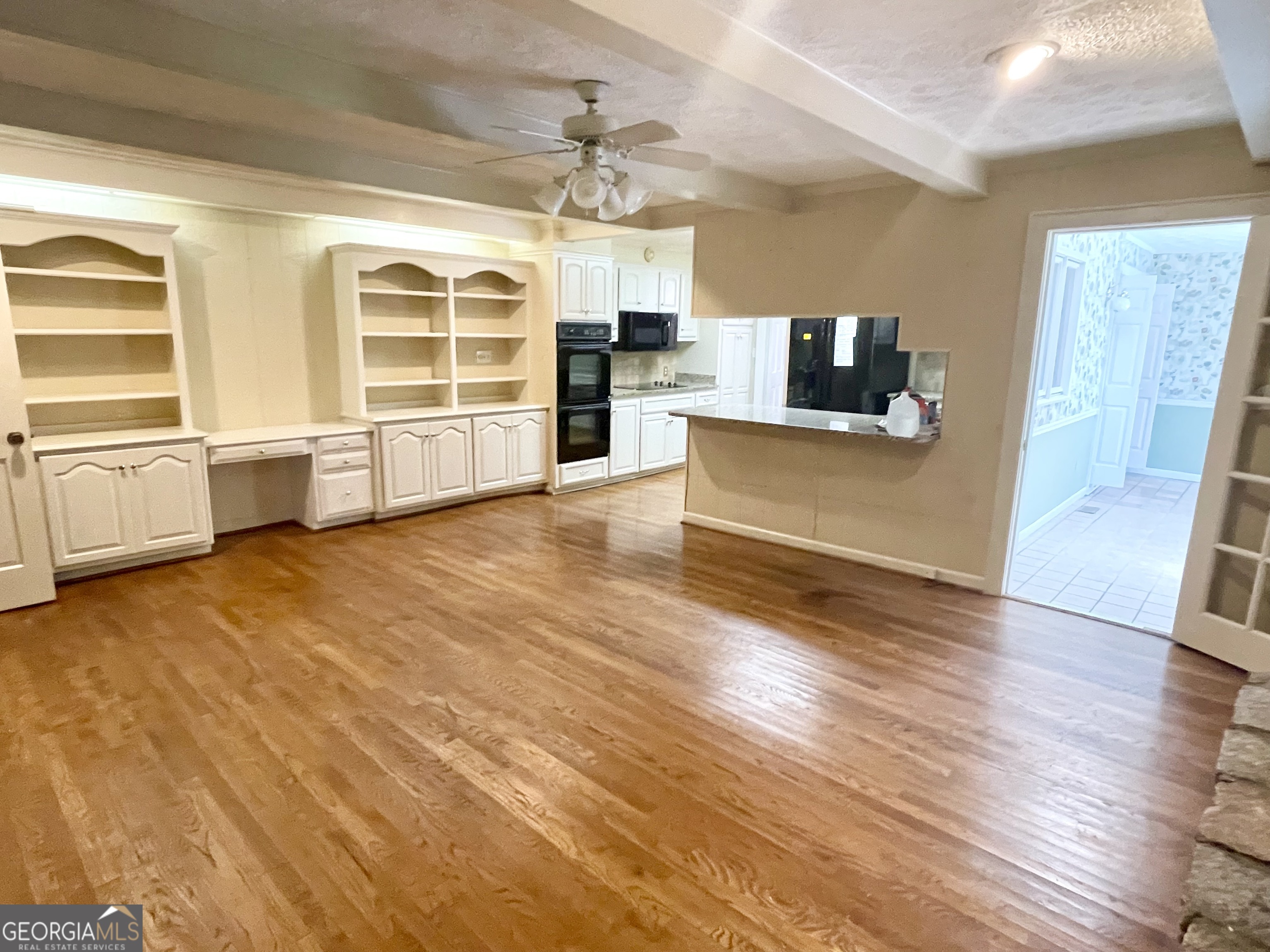 11 Cumberland Drive Southeast Rome, GA 30161 - Photo 16 of 29 a large living room with stainless steel appliances wooden floors and view kitchen