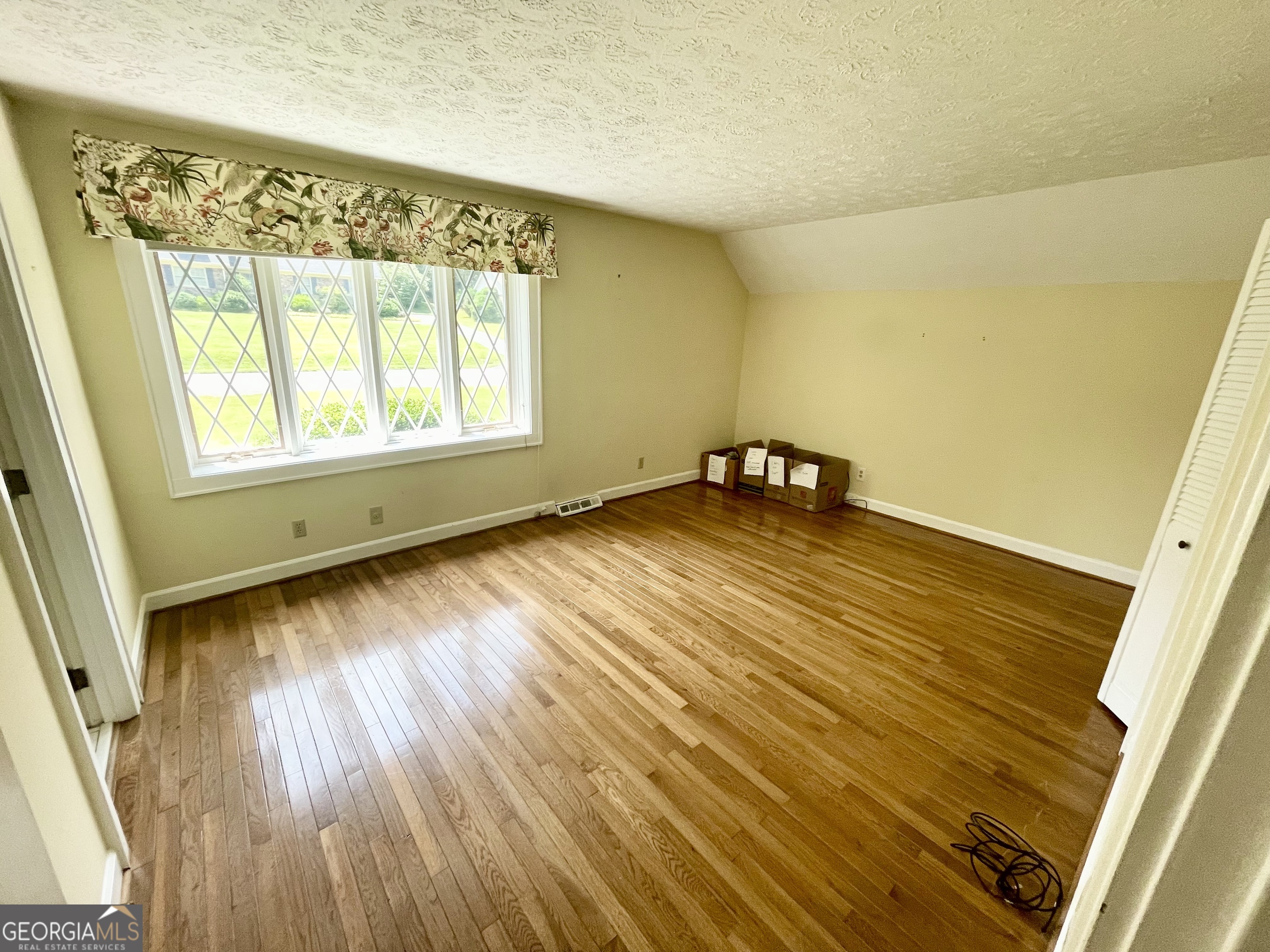 11 Cumberland Drive Southeast Rome, GA 30161 - Photo 26 of 29 a view of an empty room with wooden floor and a window