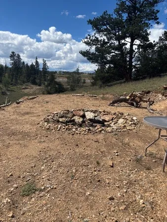 a view of outdoor space with trees all around