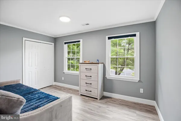 a work room with furniture and a wooden floor