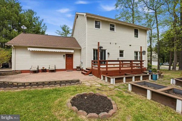 a view of a house with pool and chairs