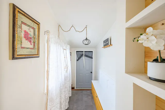 a view of a hallway with paintings on the wall