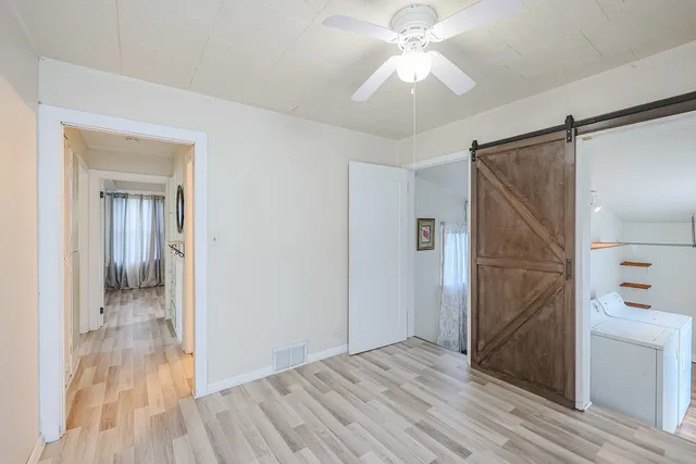 wooden floor in an empty room with a bathroom