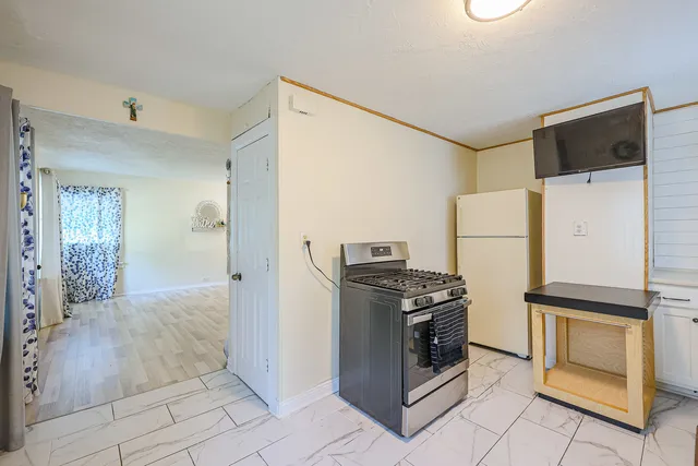 a kitchen with a stove and a refrigerator