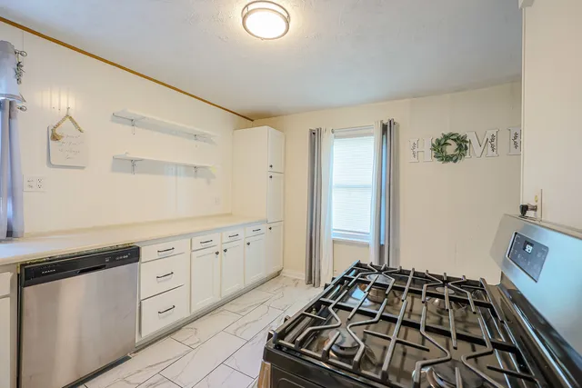 a view of large room with wooden ceiling