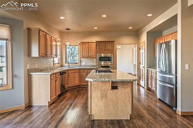 a bathroom with a sink a large mirror and a bathtub next to a window