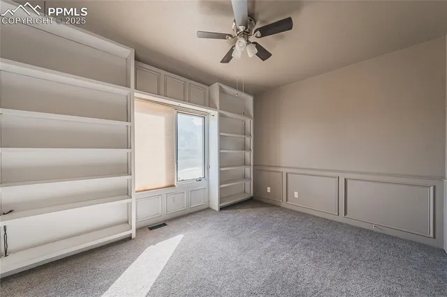 a view of a dining room with furniture a chandelier and wooden floor