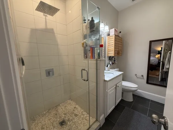 a bathroom with a toilet sink and shower