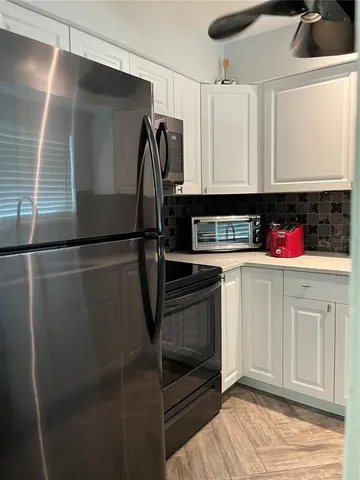 a kitchen with stainless steel appliances a refrigerator and cabinets