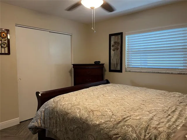 a bedroom with a bed and a chandelier