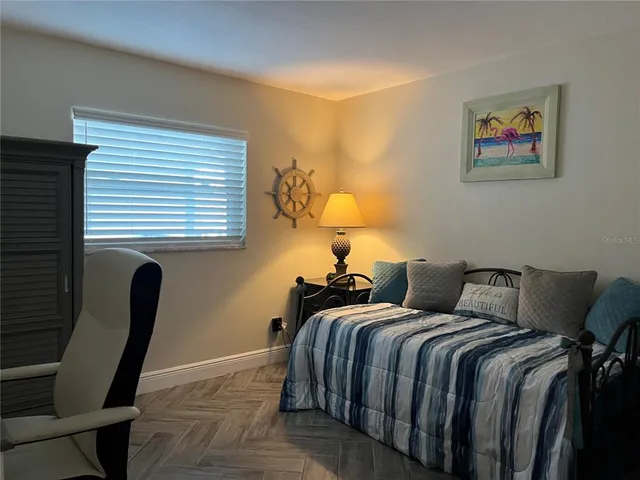 a bedroom with a bed and a chair