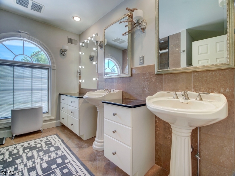 23 Ryerson Road Flemington, NJ 08822 - Photo 22 of 44 a bathroom with a sink a mirror and a shower