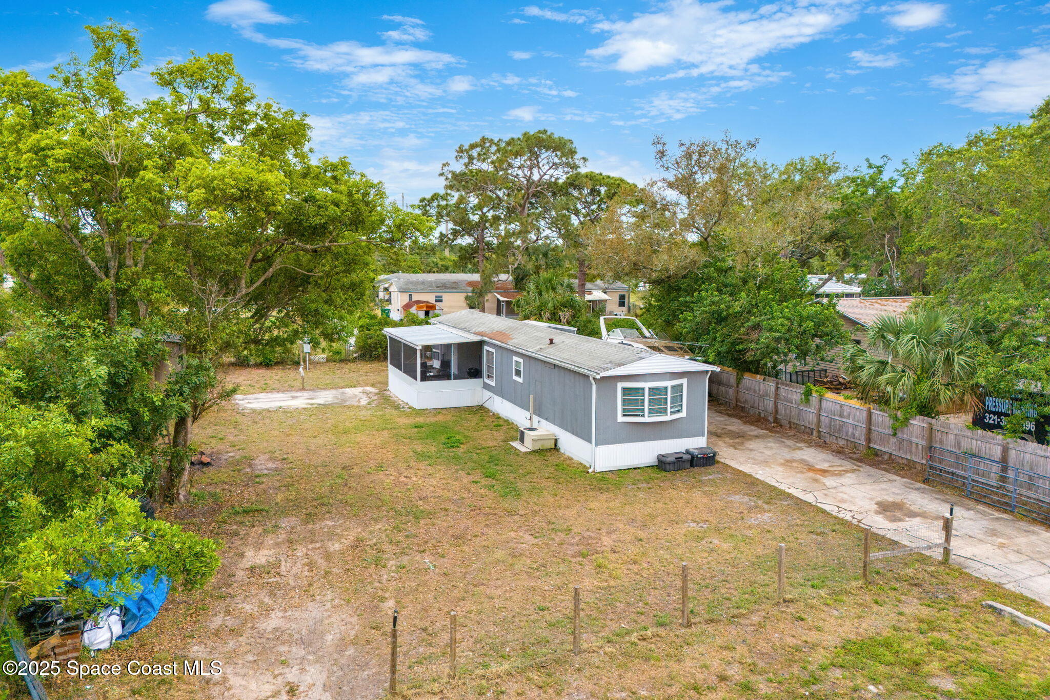 a view of a chairs and table in the backyard of the house