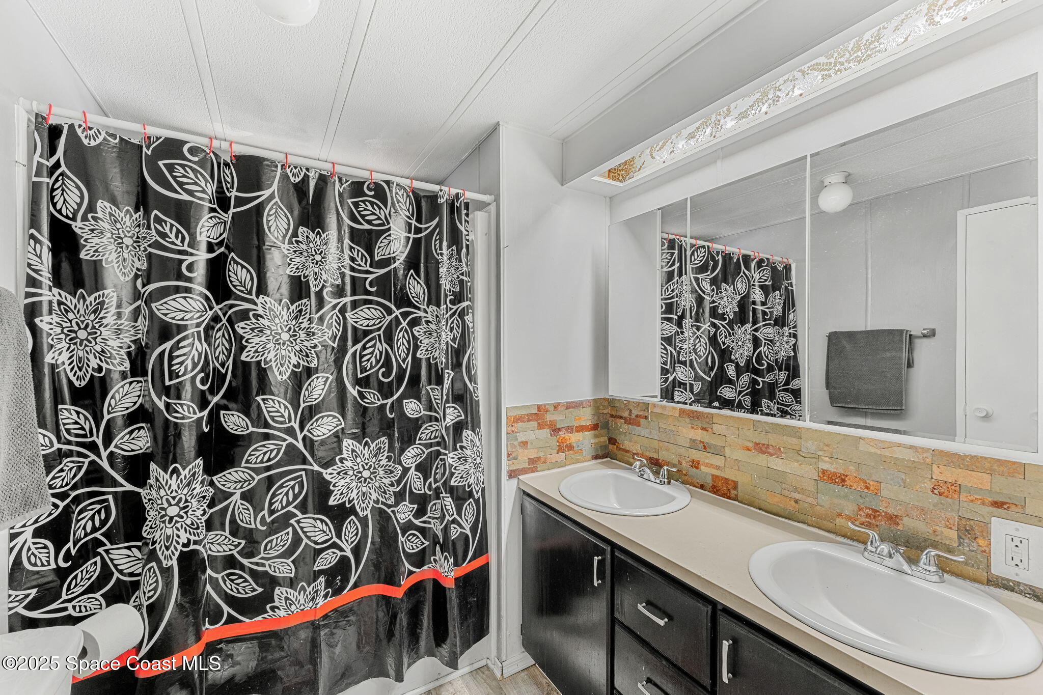 517 Bowman Boulevard Cocoa, FL 32927 - Photo 23 of 38 a bathroom with a sink and a mirror