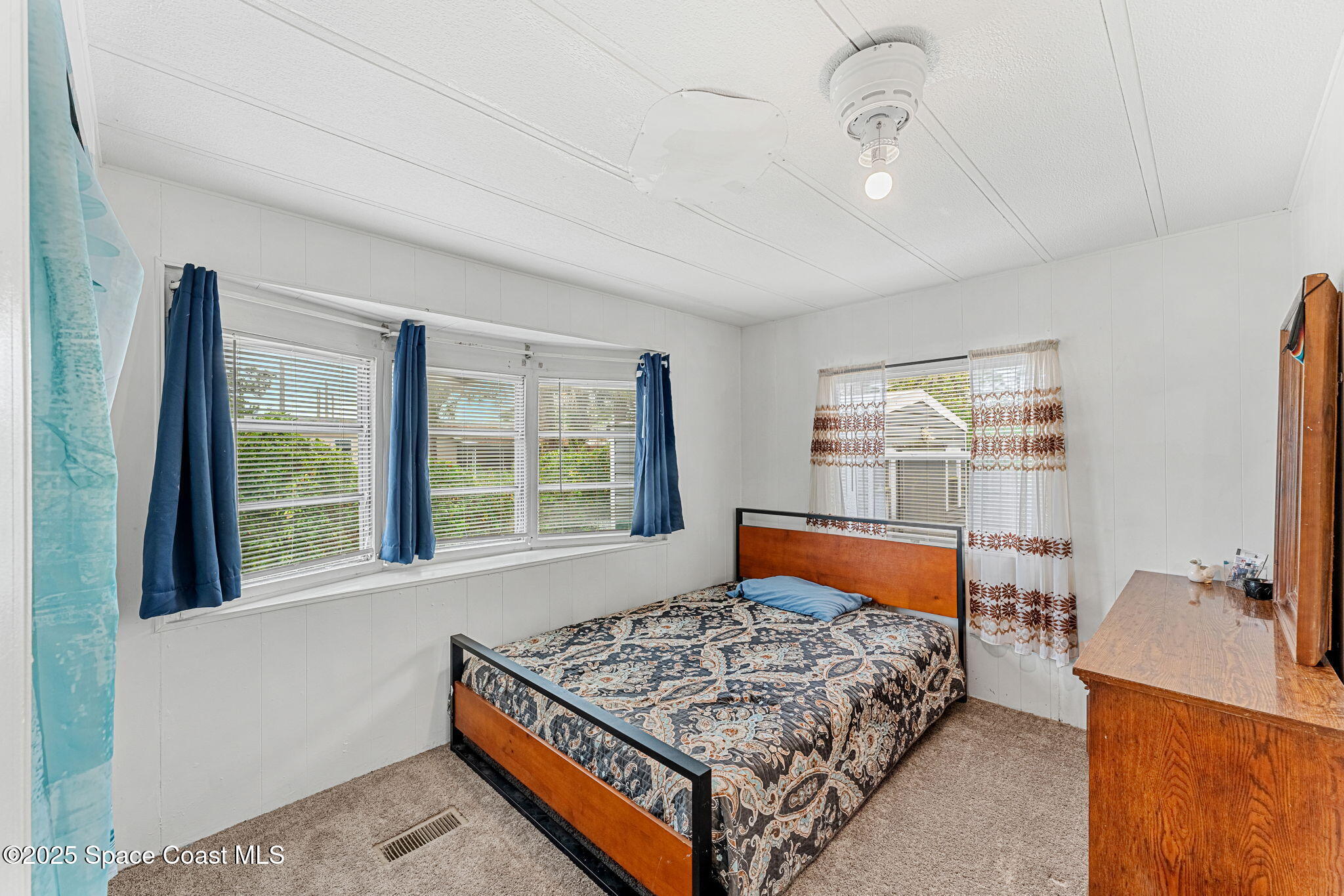 517 Bowman Boulevard Cocoa, FL 32927 - Photo 24 of 38 a bedroom with a bed and glass window