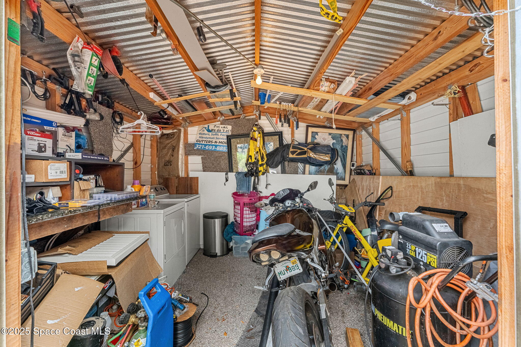 517 Bowman Boulevard Cocoa, FL 32927 - Photo 31 of 38 a view of a storage room with washer and dryer