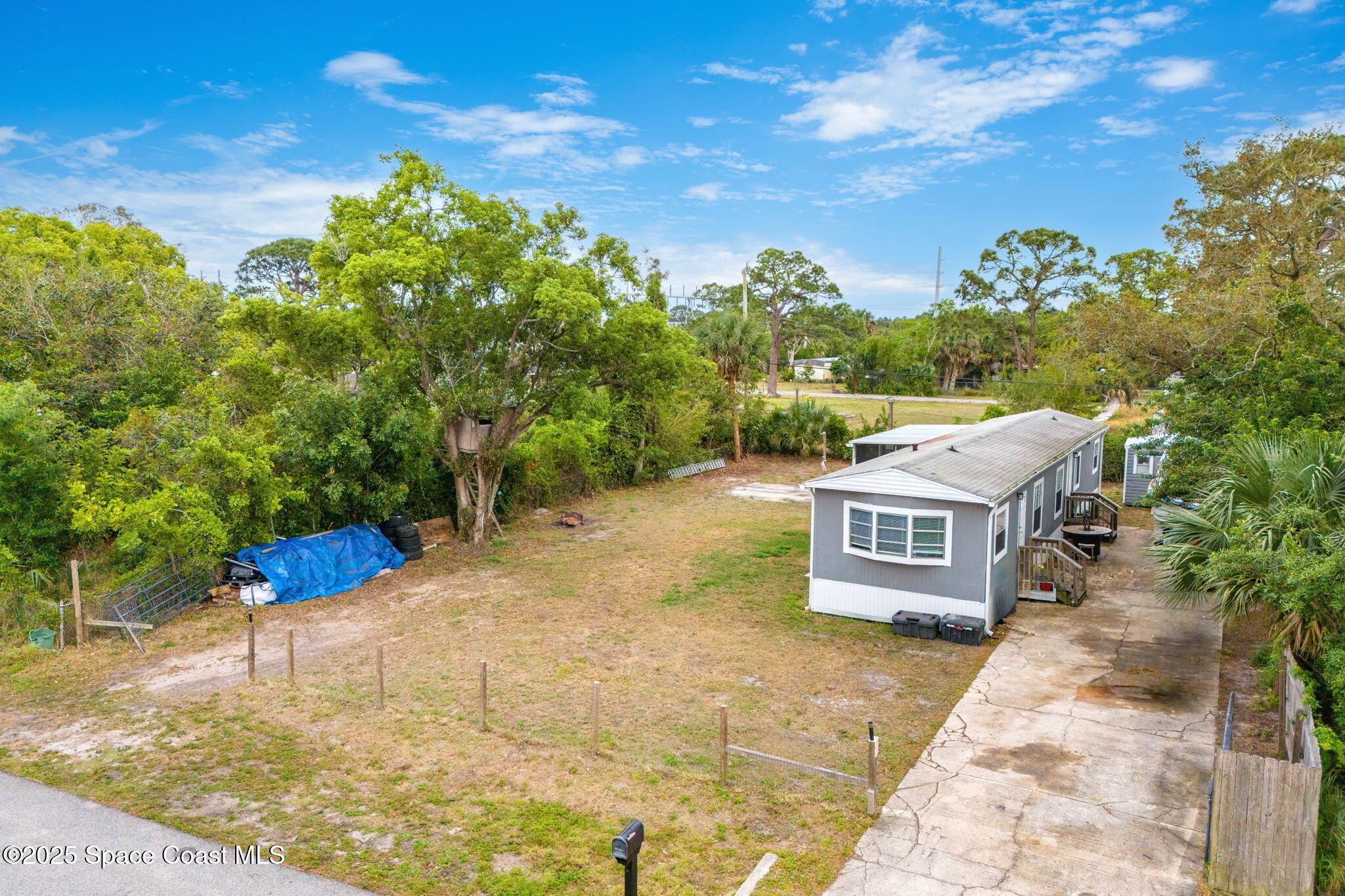 517 Bowman Boulevard Cocoa, FL 32927 - Photo 5 of 38 a swimming pool with trees in the background