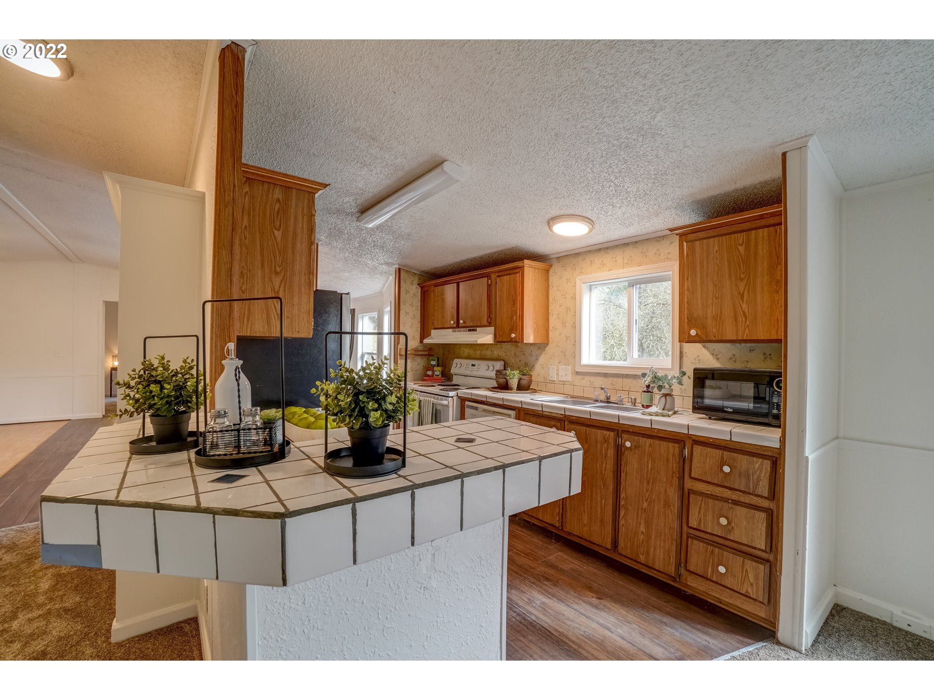 6967 Southwest Mill Road Gaston, OR 97119 - Photo 8 of 28 a kitchen with stainless steel appliances granite countertop a sink counter space and cabinets