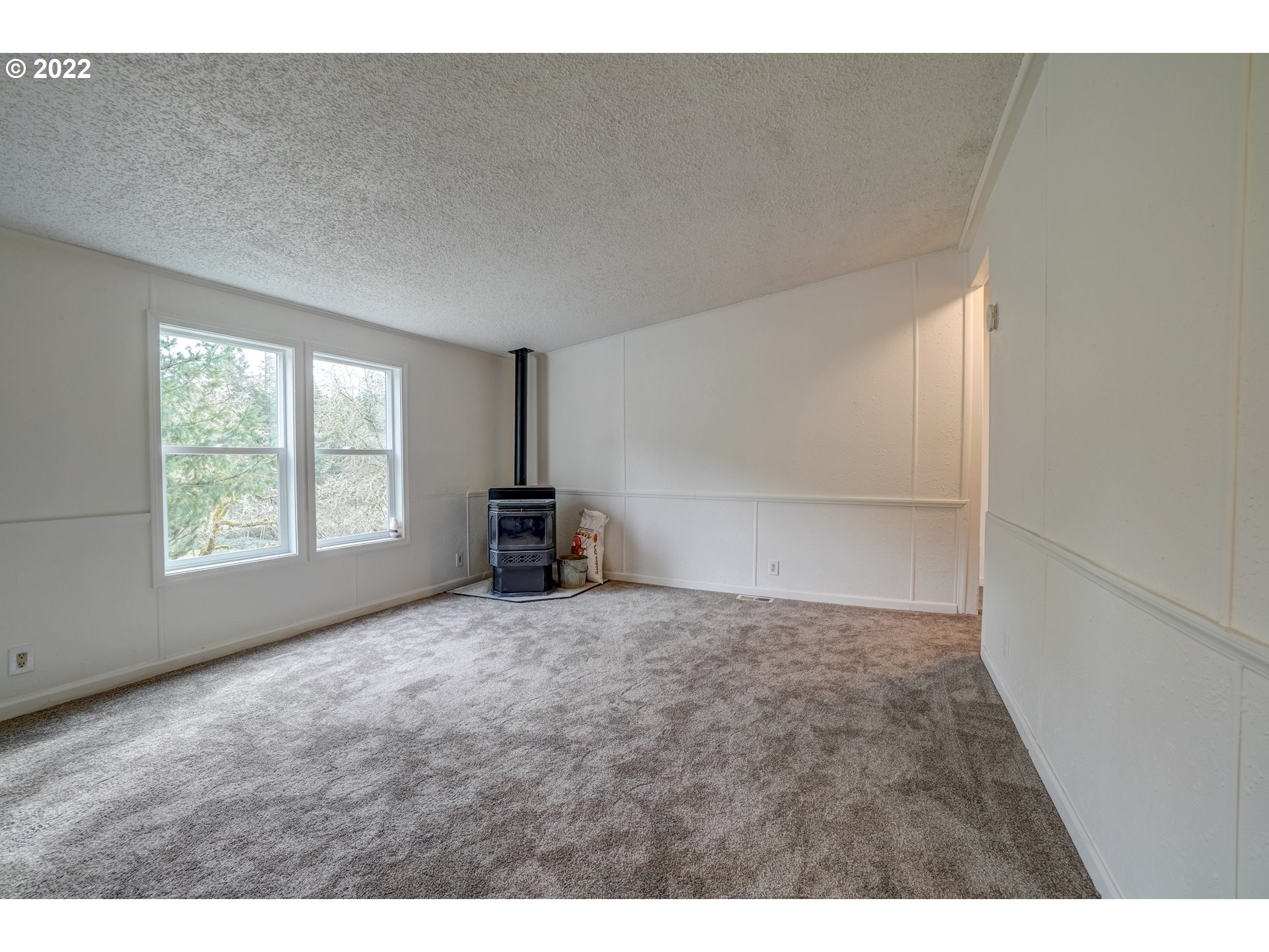 6967 Southwest Mill Road Gaston, OR 97119 - Photo 9 of 28 a view of an empty room with a window