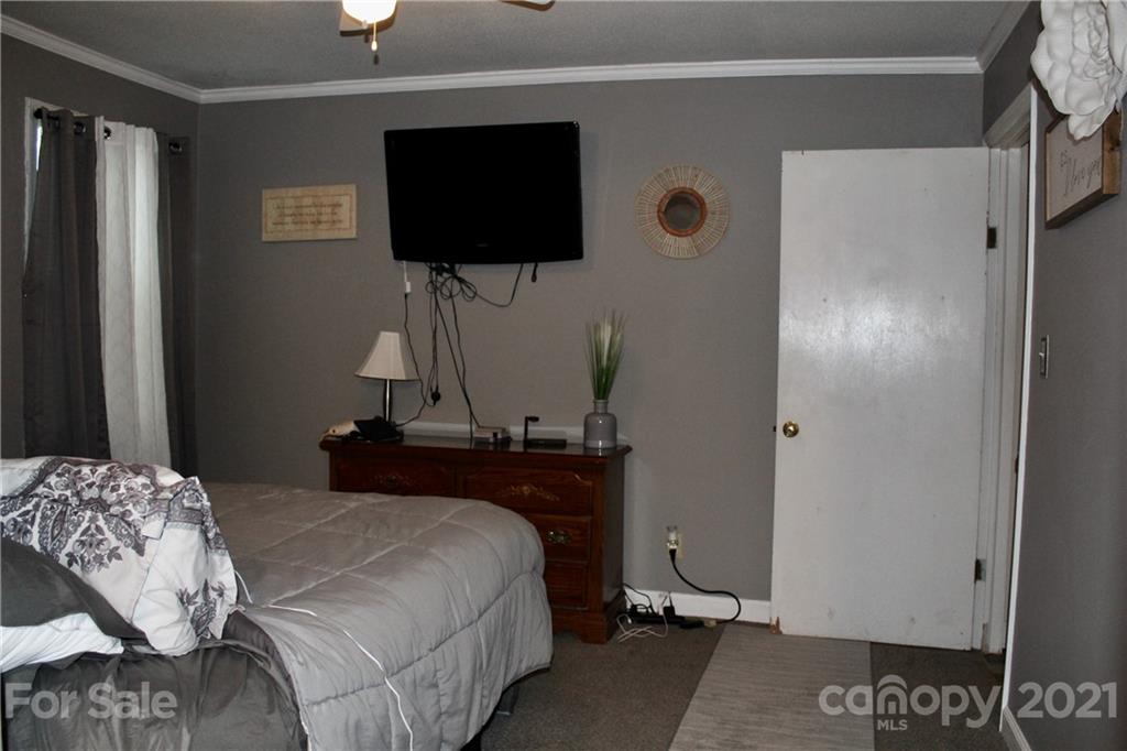 2411 Poors Ford Road Rutherfordton, NC 28139 - Photo 11 of 19 a bedroom with a bed and a flat screen tv