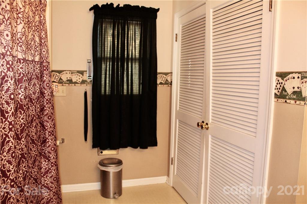 2411 Poors Ford Road Rutherfordton, NC 28139 - Photo 13 of 19 a bathroom with a toilet and a shower curtain