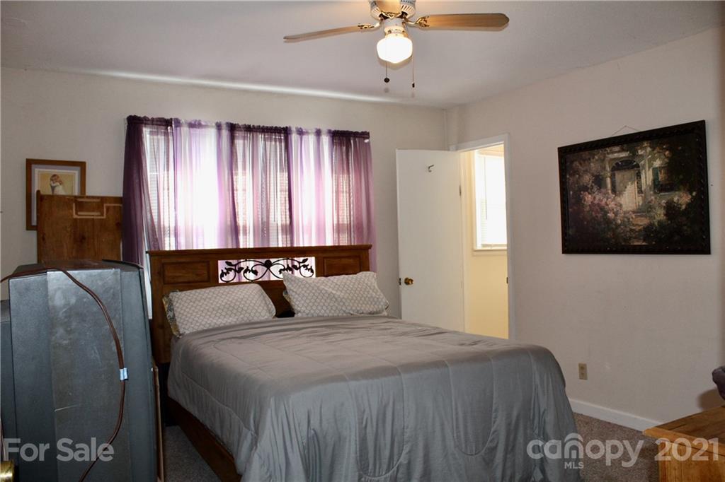 2411 Poors Ford Road Rutherfordton, NC 28139 - Photo 14 of 19 a bedroom with a large bed and a chandelier