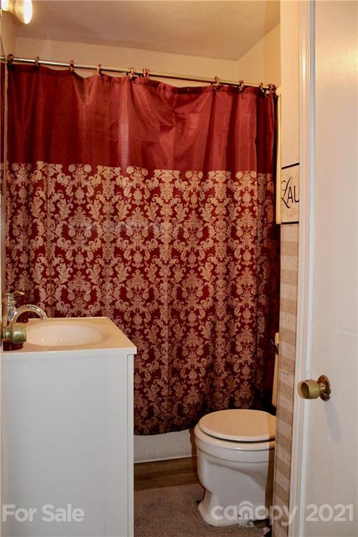 2411 Poors Ford Road Rutherfordton, NC 28139 - Photo 16 of 19 a bathroom with a toilet and a shower curtain