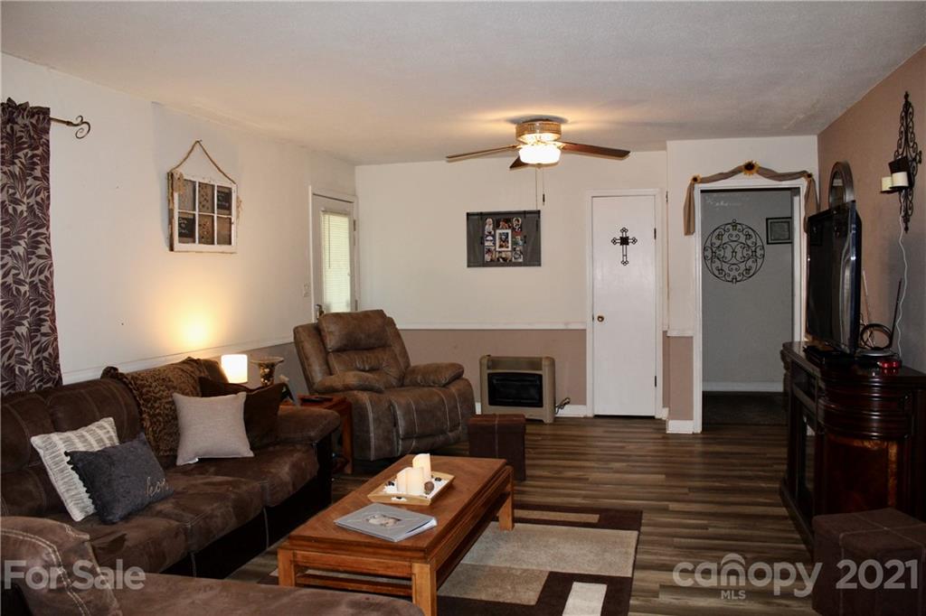 2411 Poors Ford Road Rutherfordton, NC 28139 - Photo 4 of 19 a living room with furniture a flat screen tv and a fireplace